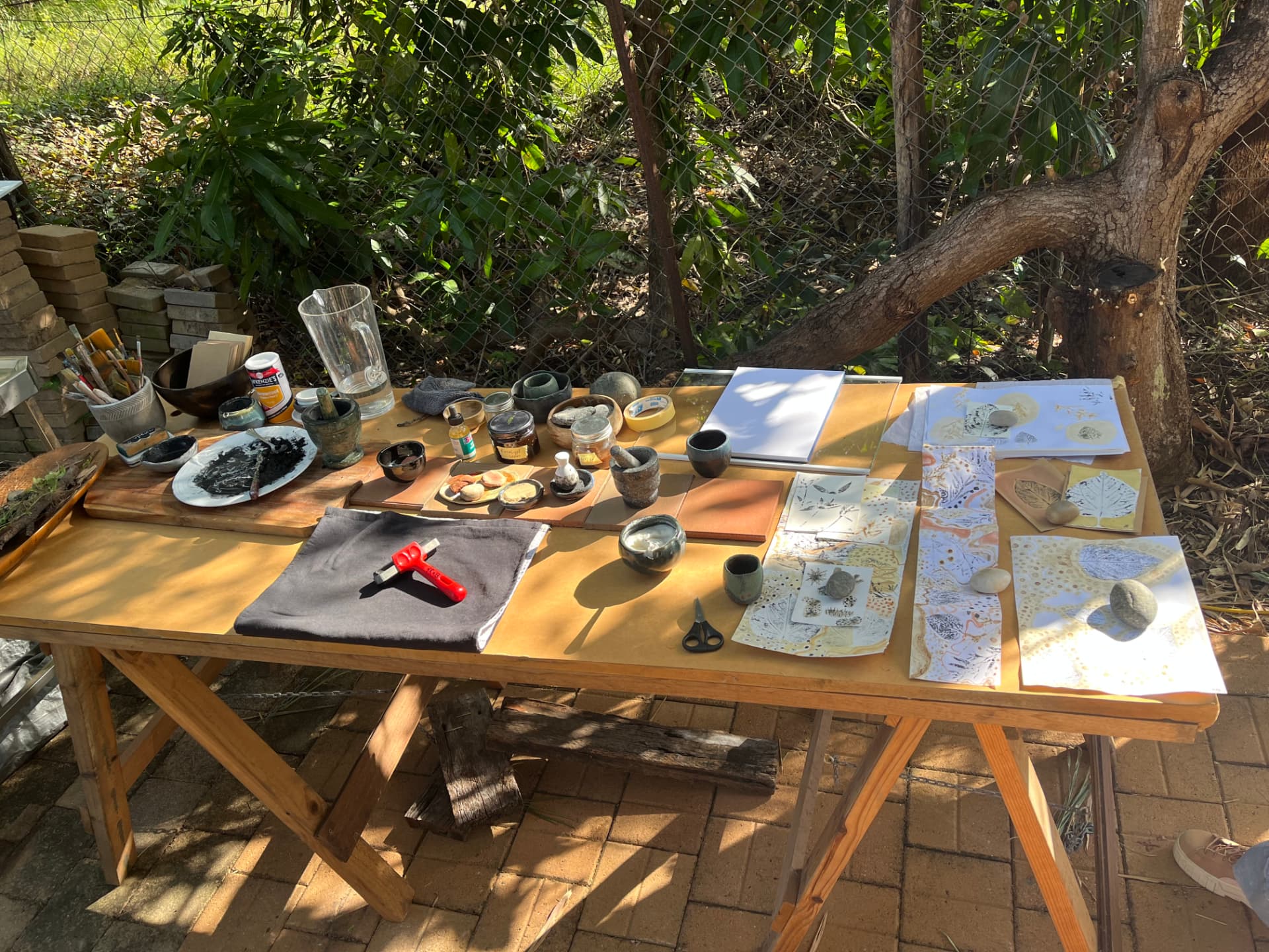 The making table laid out with natural pigments, tools and prints