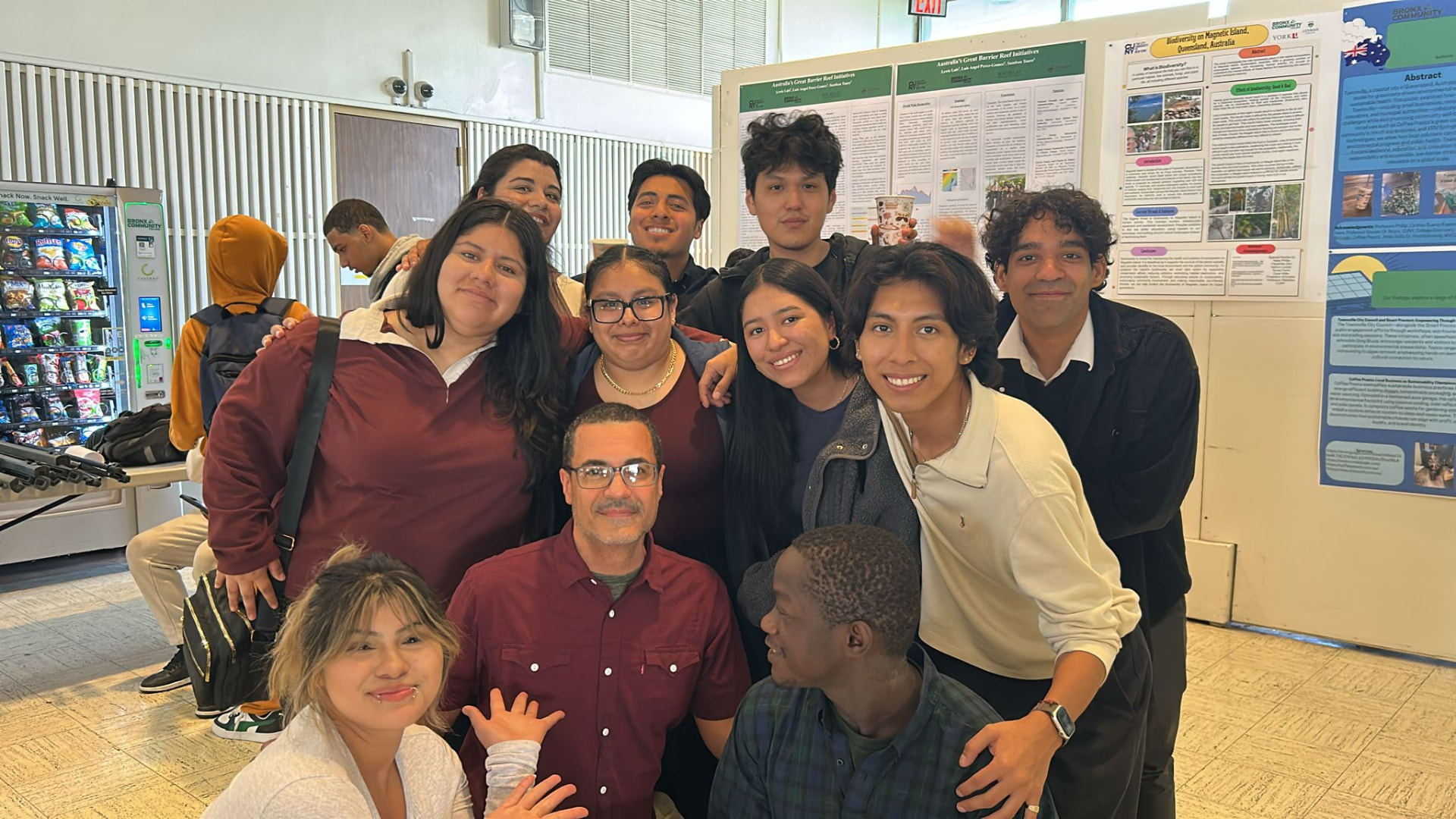 CUNY students gathered together in front of their poster display