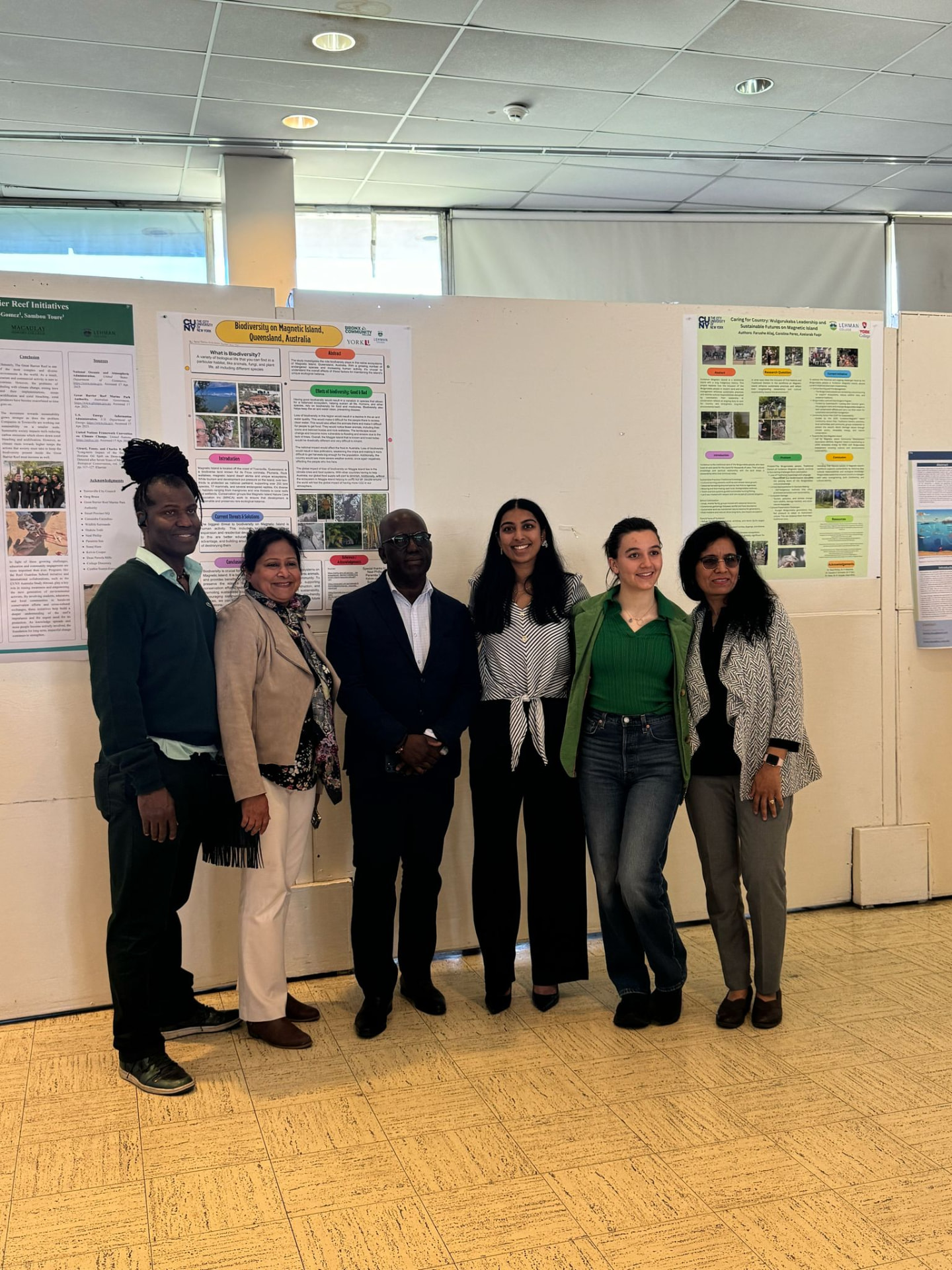 CUNY students and faculty standing before their research posters at CUNY Earth Day